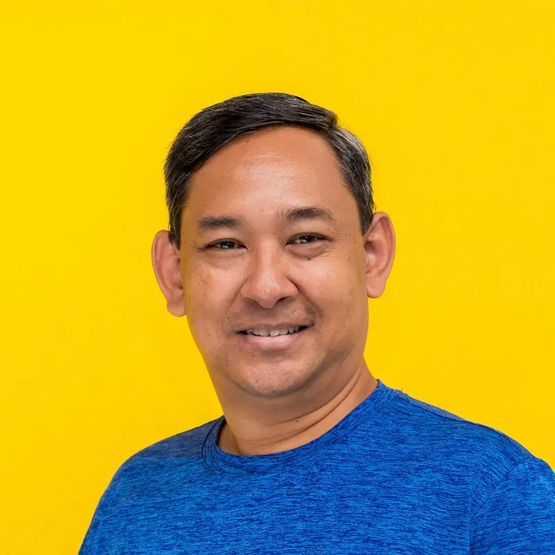 A man in a plaid shirt is smiling for the camera.