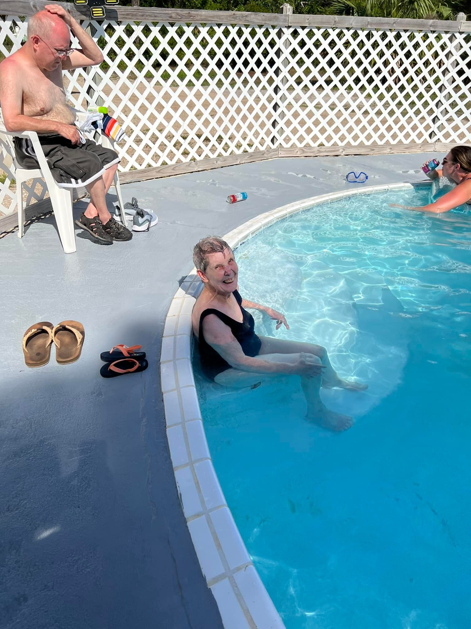 A few people are hanging out at the pool