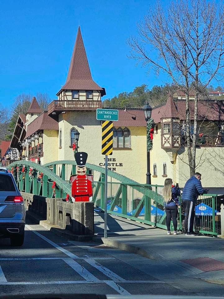 a bridge over a body of water with a building in the background