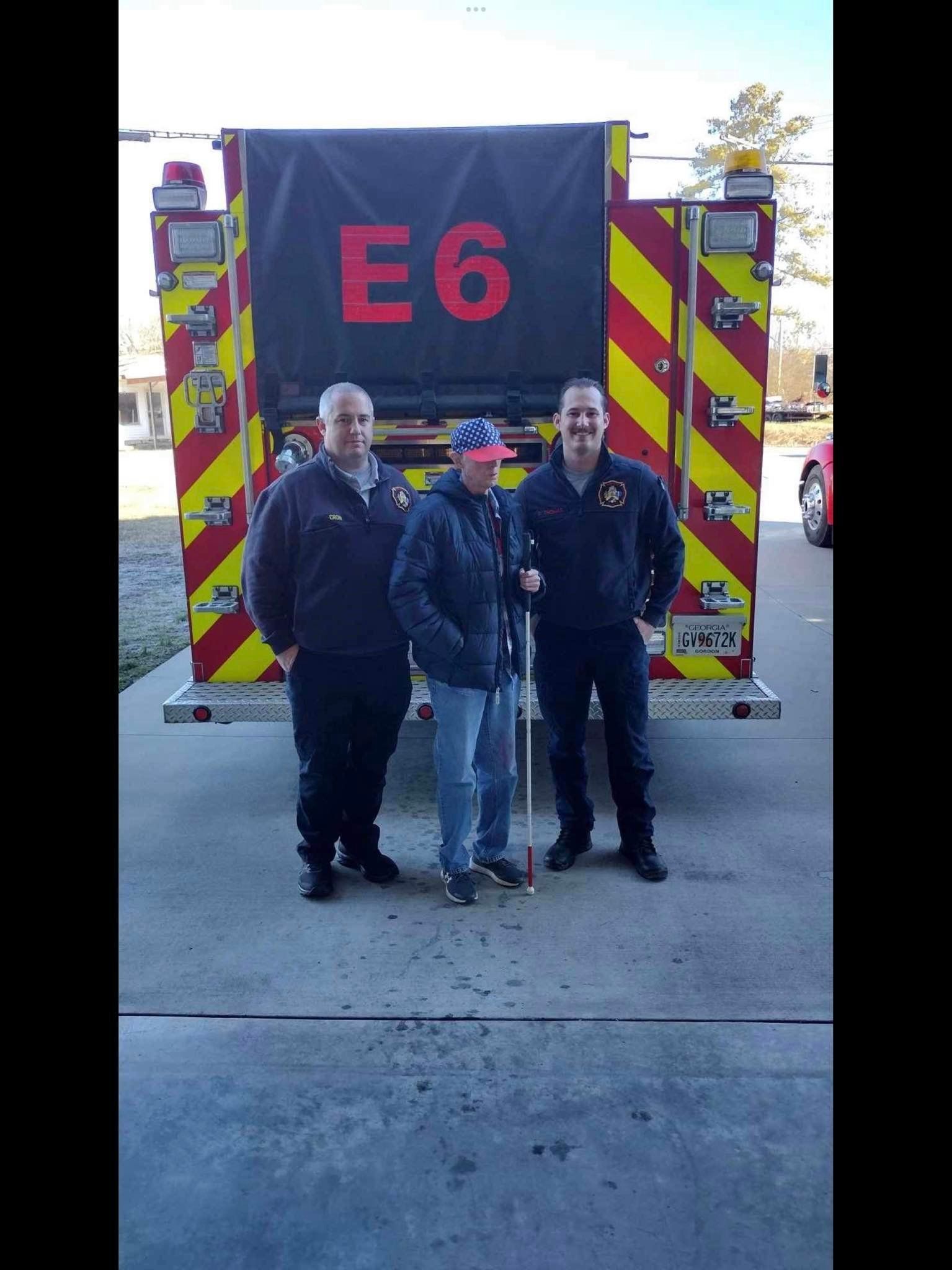 a group of 3 people smiling and taking a photo together outside
