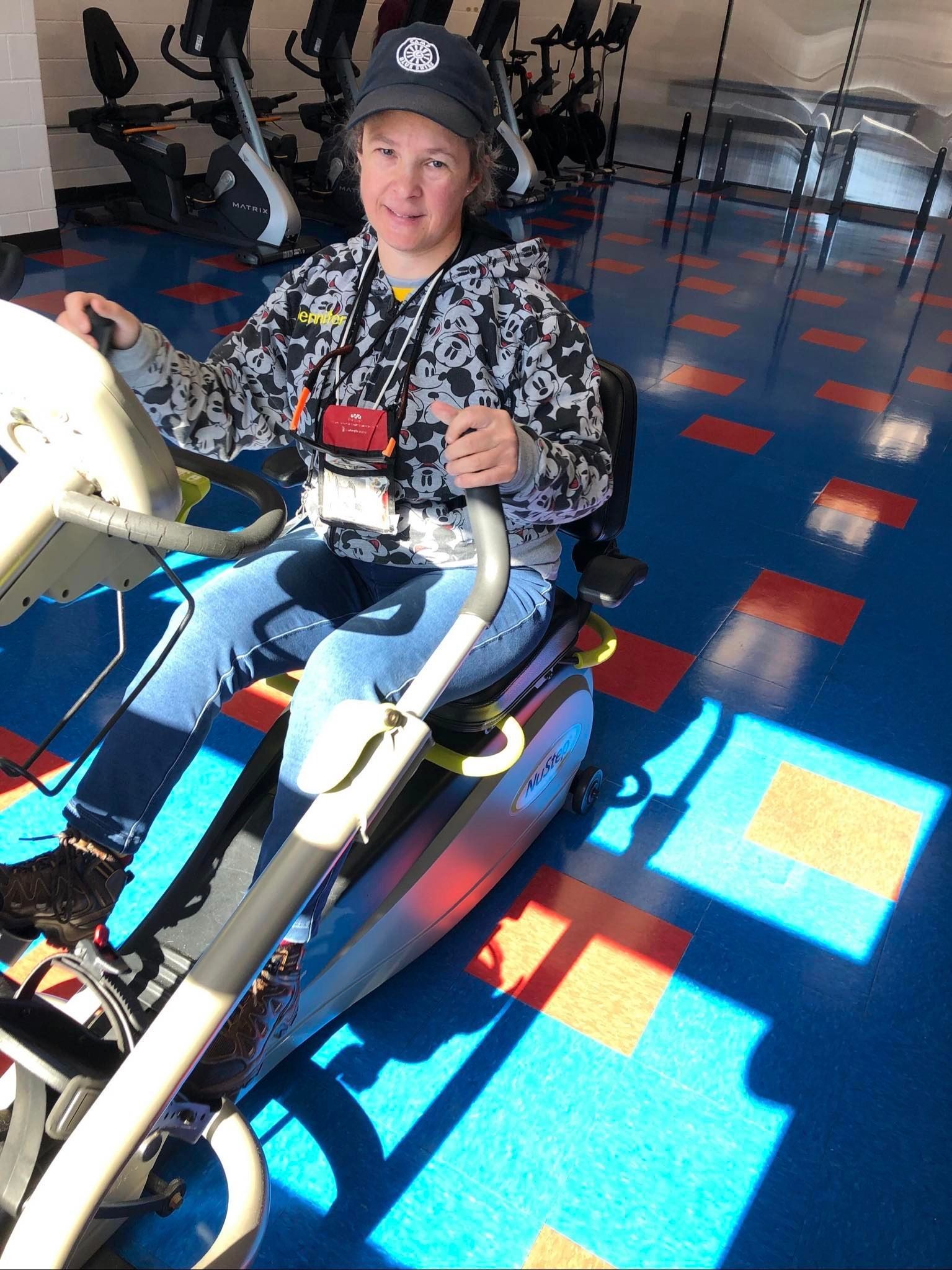 a person is riding an exercise bike in a gym