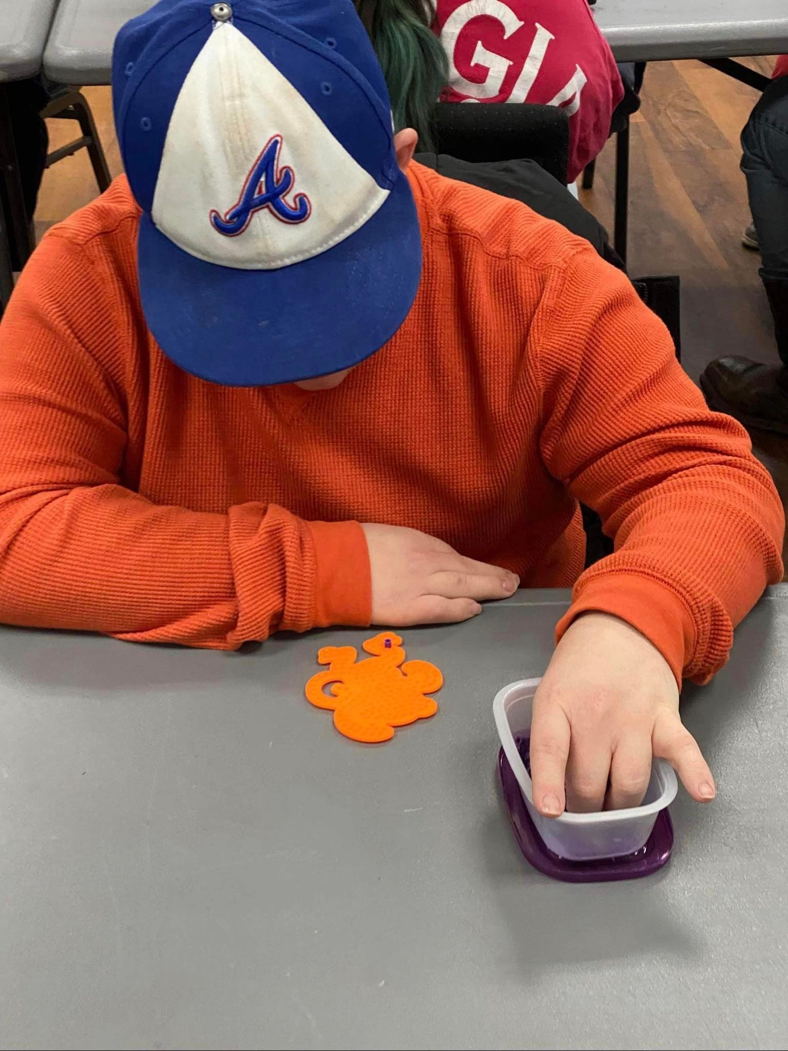 a person wearing a hat with the letter a on it