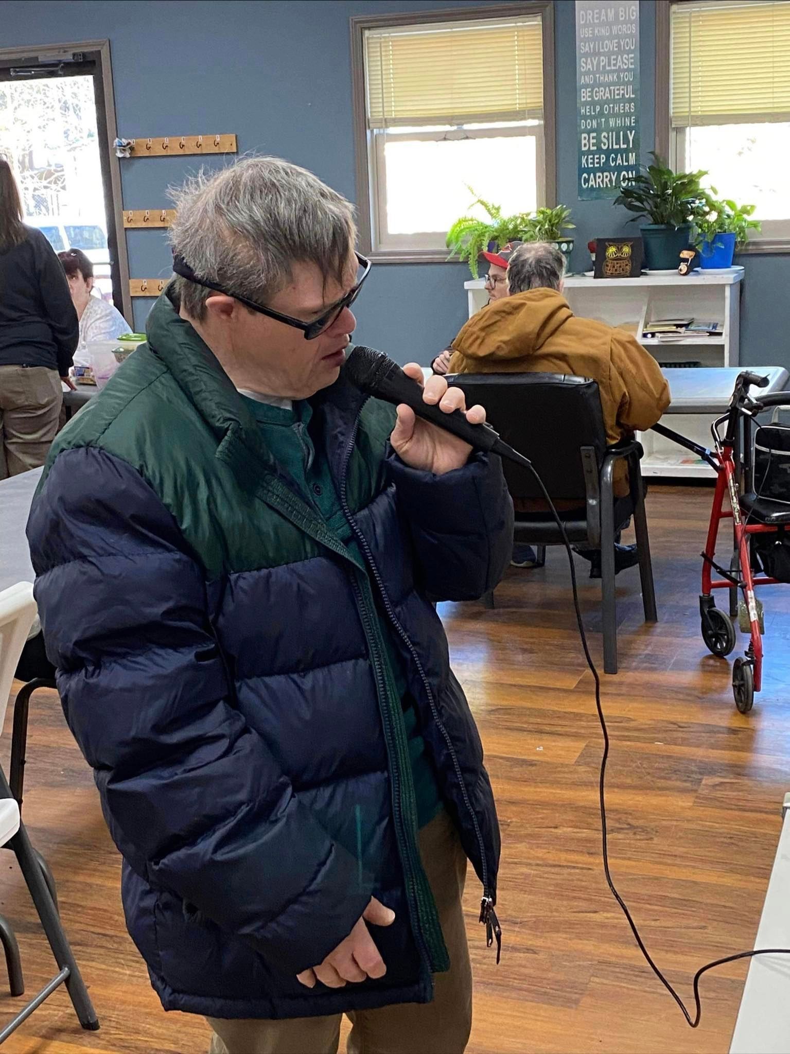 a man is singing into a microphone in a room .