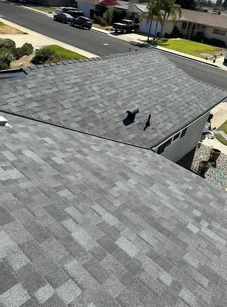 An aerial view of a roof of a house in a residential area.