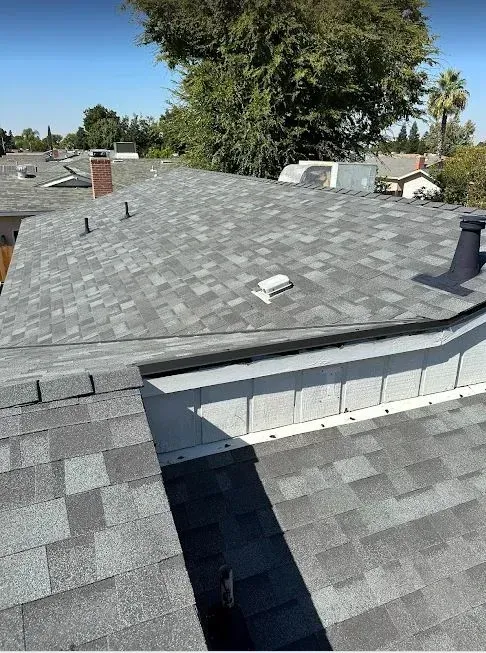 A picture of a roof with a chimney on it.