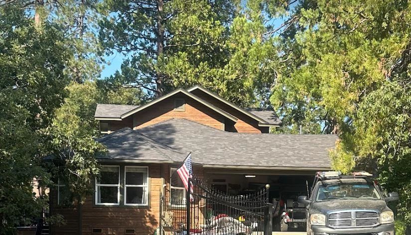 A house with a truck parked in front of it.