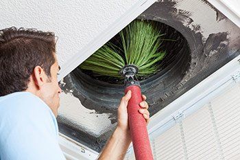 Air Ducts — Man Dusting An Air Duct in Columbus, OH