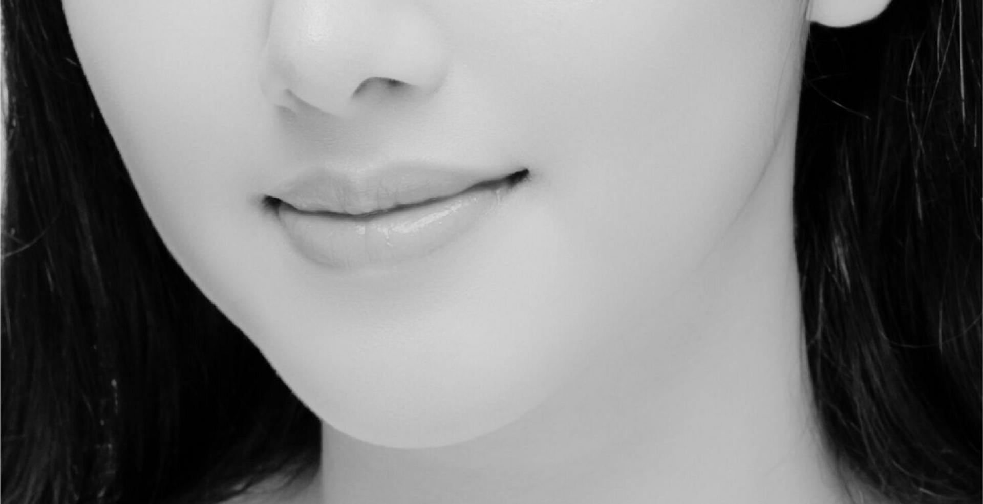 A close up of a woman 's face in a black and white photo.