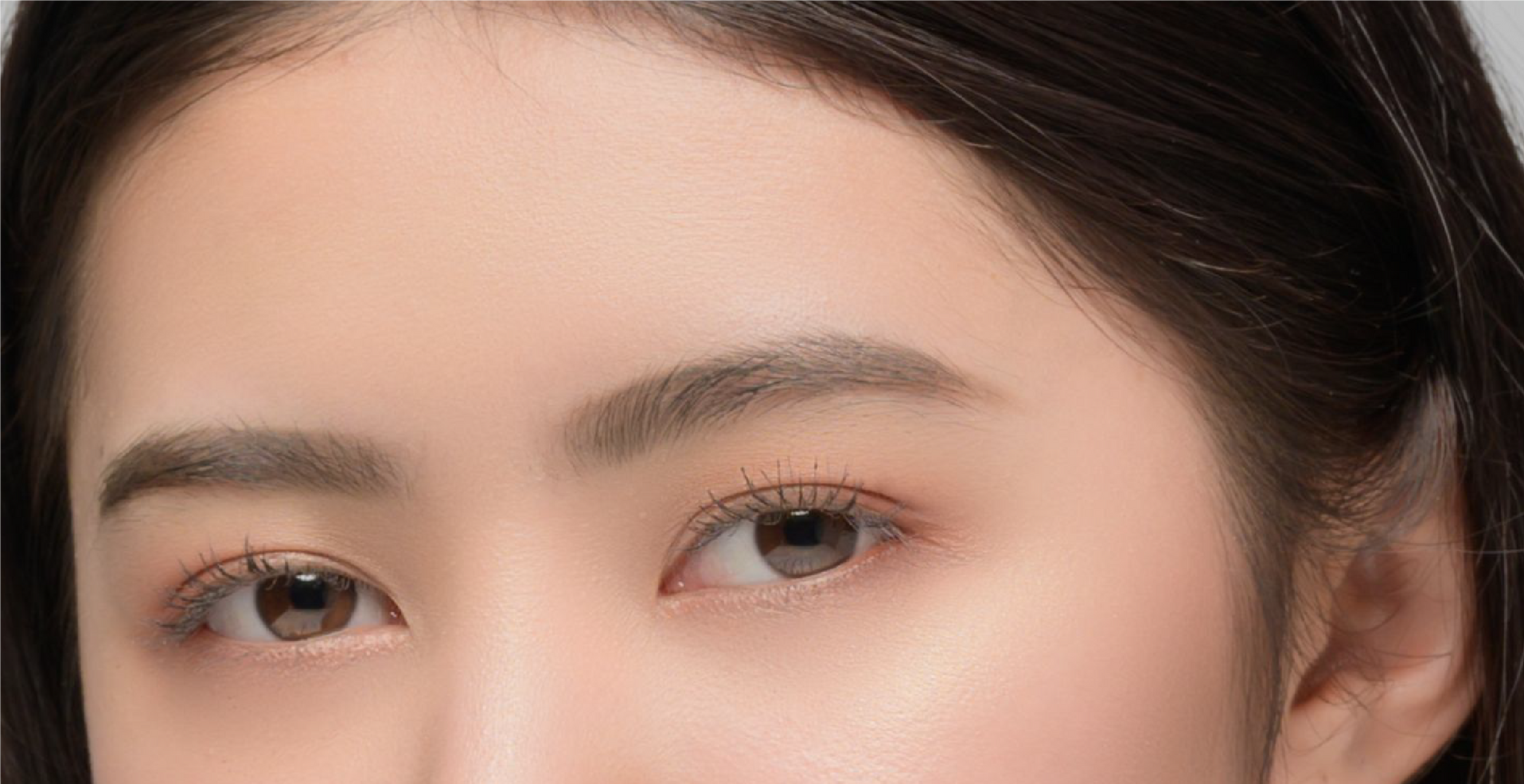 A close up of a woman 's eyes with makeup on.