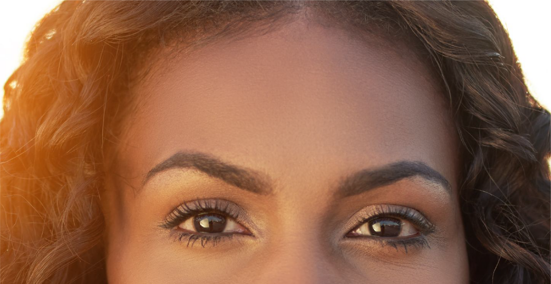 A close up of a woman 's eyes and forehead.