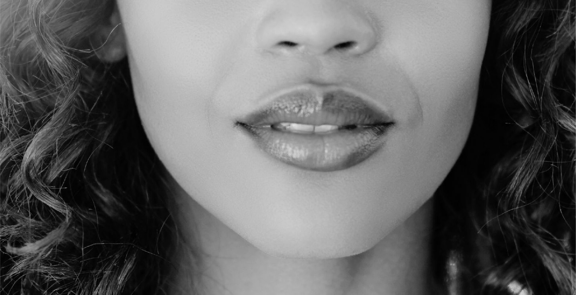 A close up of a woman 's lips in a black and white photo.