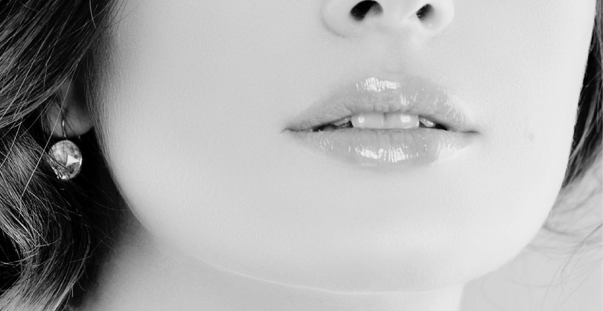 A close up of a woman 's lips and nose in a black and white photo.