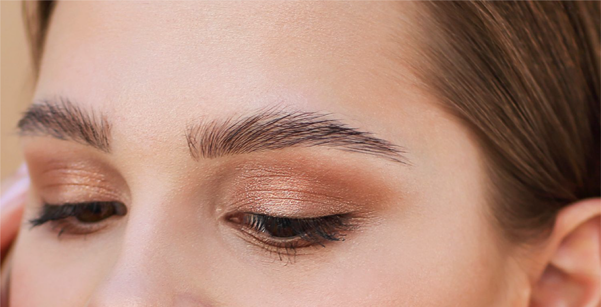 A close up of a woman 's eye with makeup on her eyebrows.