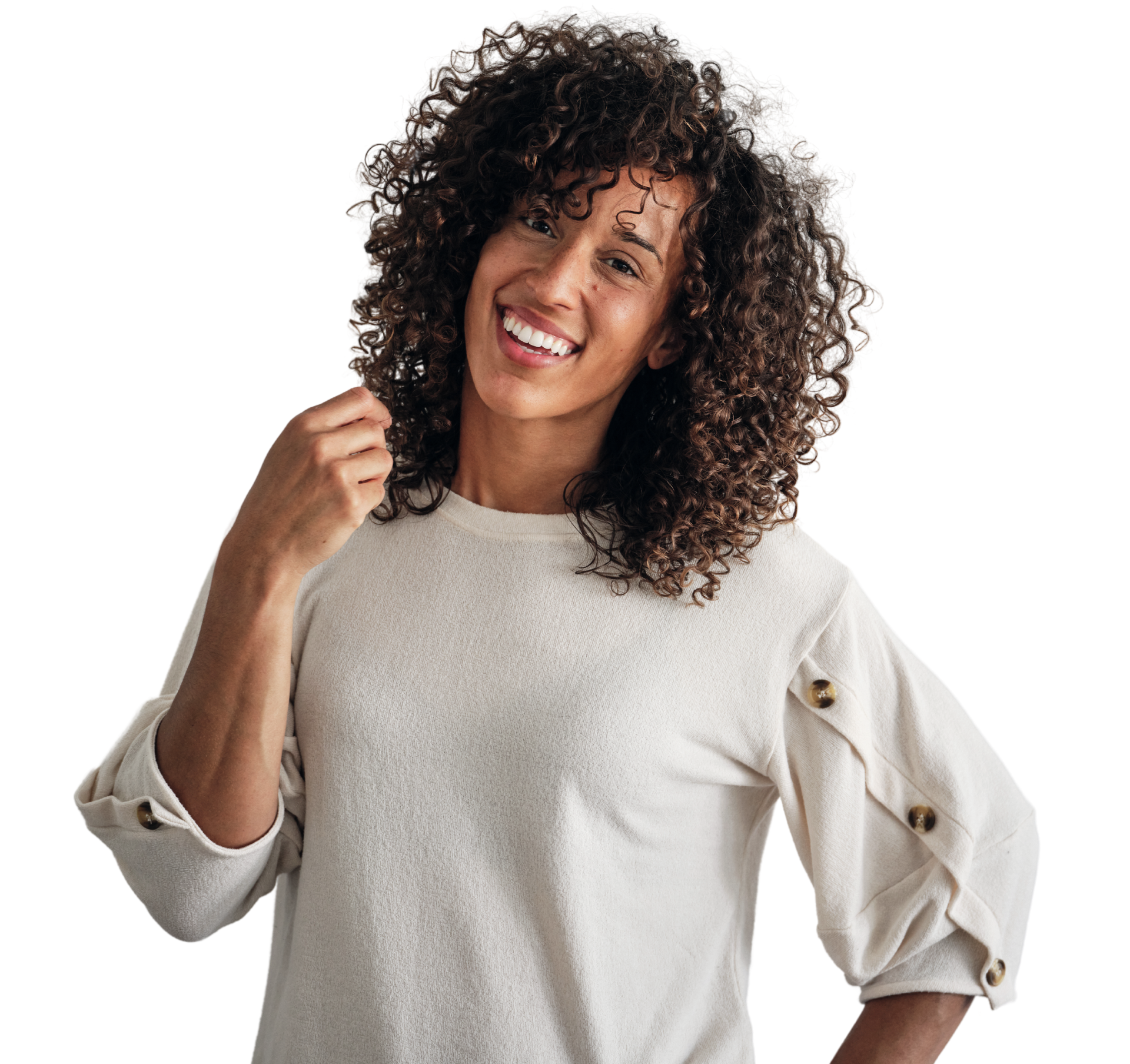A woman with curly hair is wearing a white sweater and smiling.