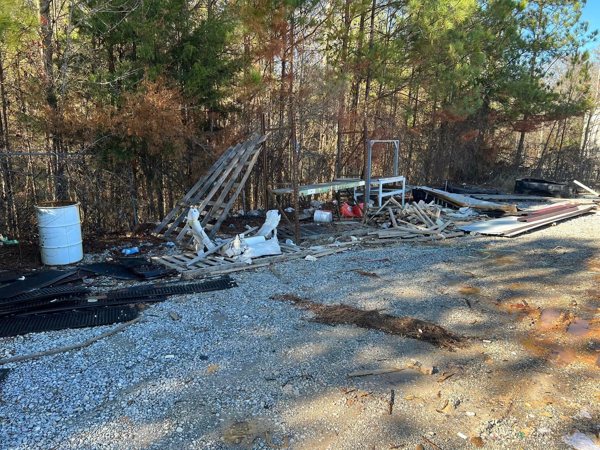 There is a lot of trash on the ground in the woods.