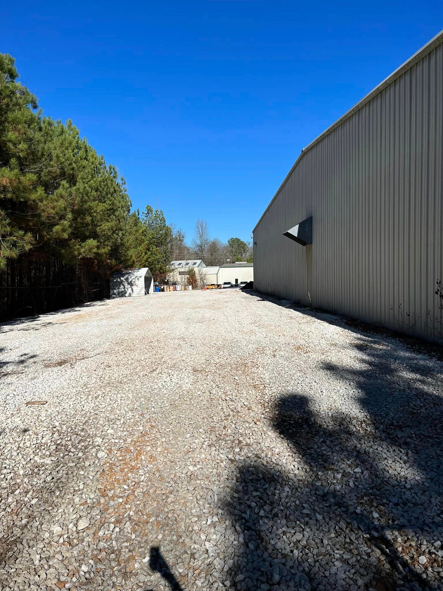 A large building with a lot of gravel in front of it.