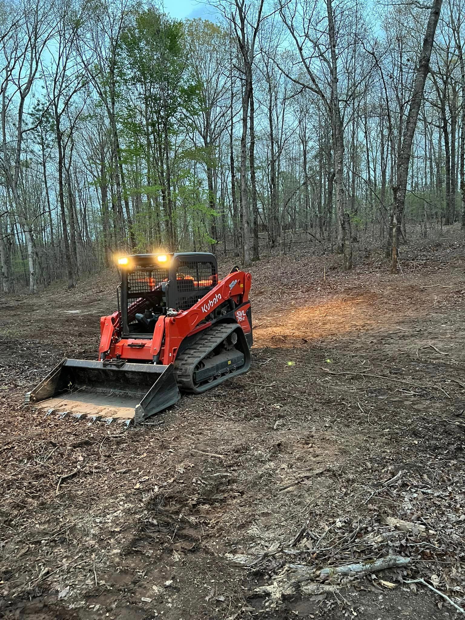 A bulldozer is driving through a lush green forest.