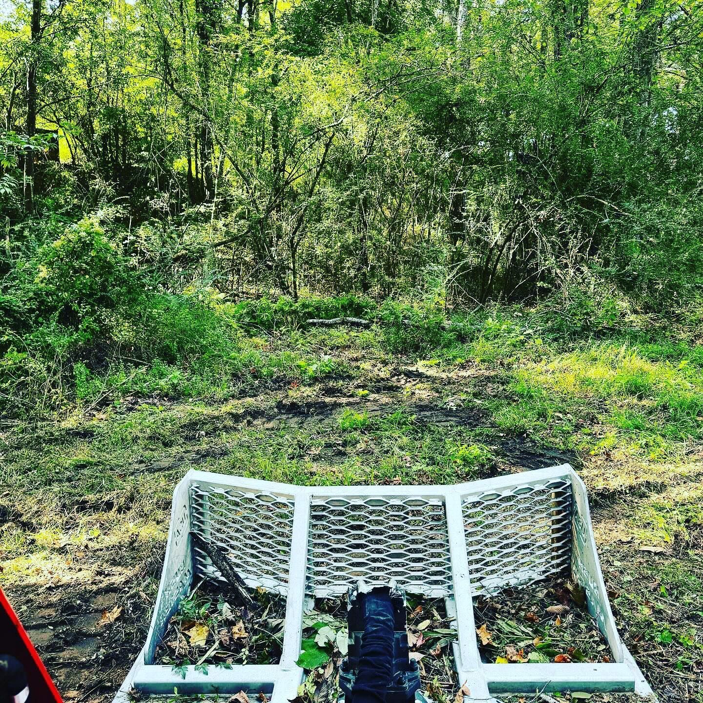 A person is riding a bike on a trail in the woods.