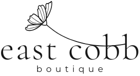 A black and white logo for east cobb boutique with a flower on a string.