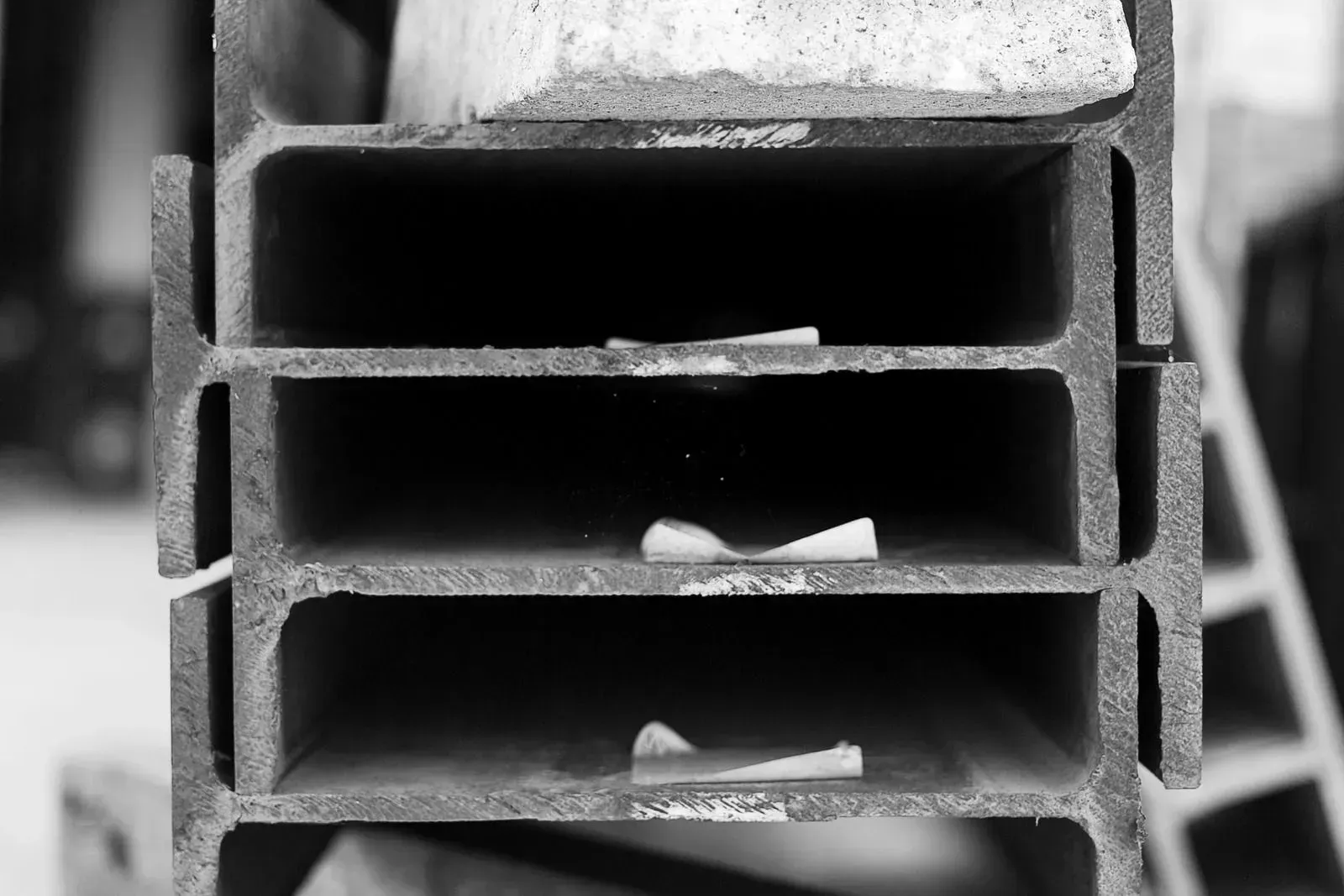 A black and white photo of a stack of metal bars.