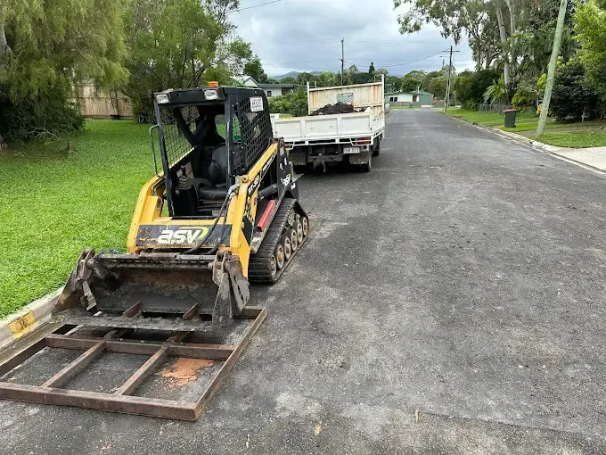 Yellow Excavator the side of a road — Cairns Earthmoving Solutions In Gordonvale, QLD