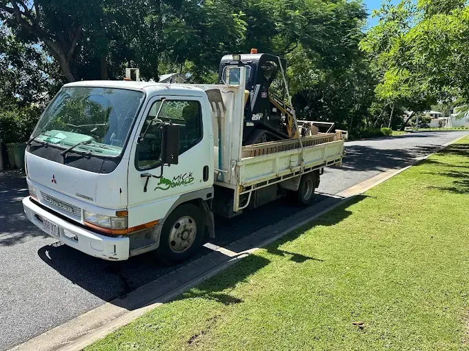White truck with a machine in the tray — Cairns Earthmoving Solutions In Smithfield, QLD