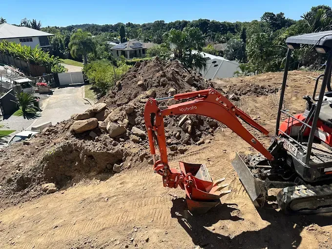 Red Excavators on a Hill — Cairns Earthmoving Solutions In Holloways Beach, QLD