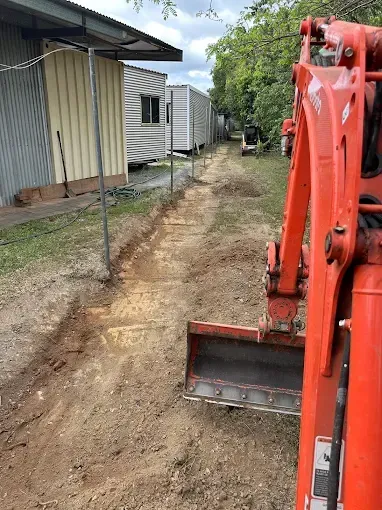 Red Excavator Digging dirt — Cairns Earthmoving Solutions In Holloways Beach, QLD