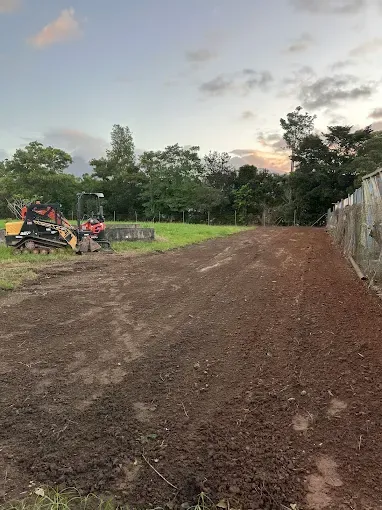 Red Excavator in a dirt field - Cairns Earthmoving Solutions In Holloways Beach, QLD