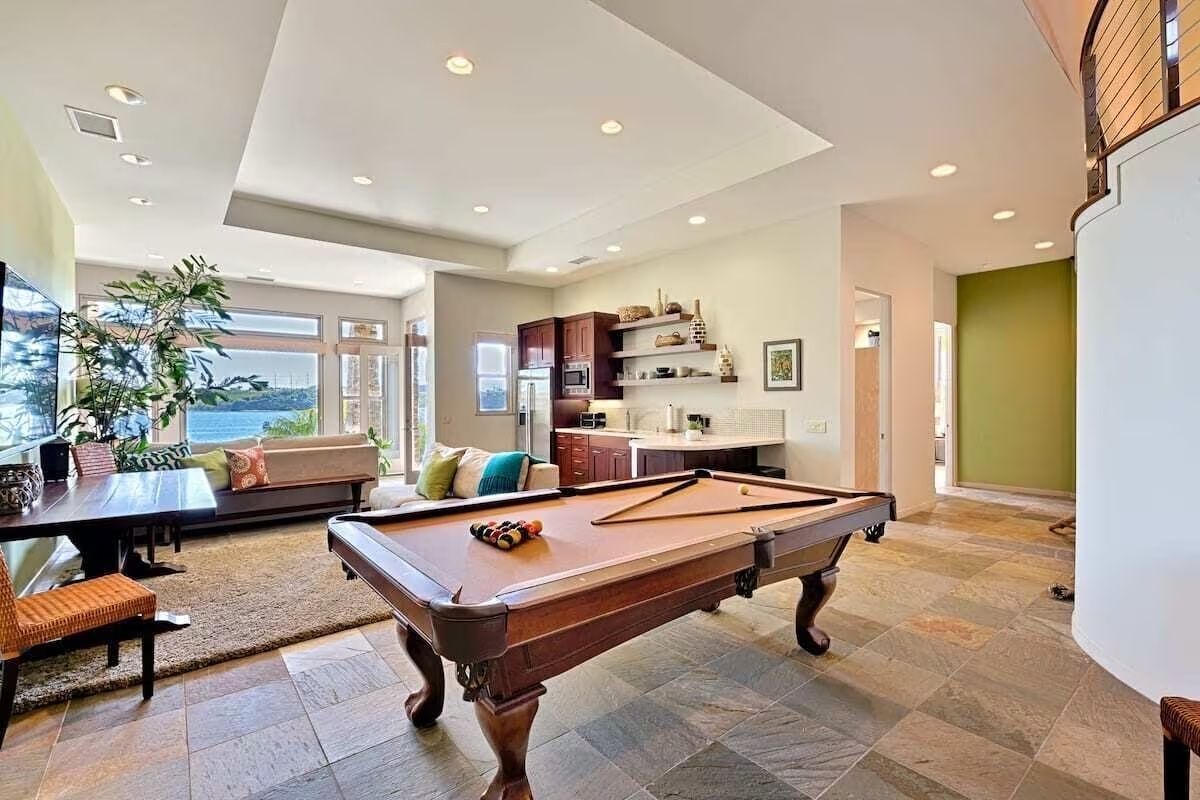a pool table is in the middle of a living room