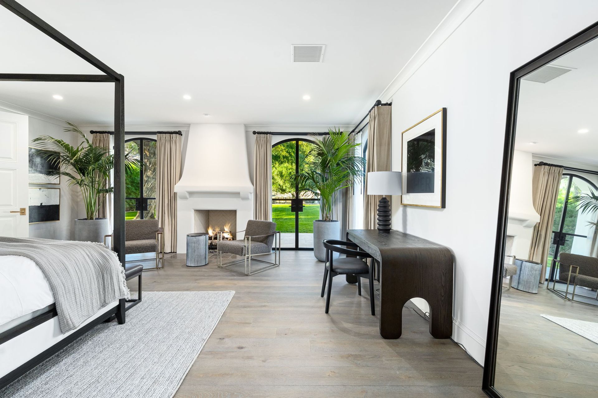 a bedroom with a large bed, dresser, nightstand and sliding glass doors