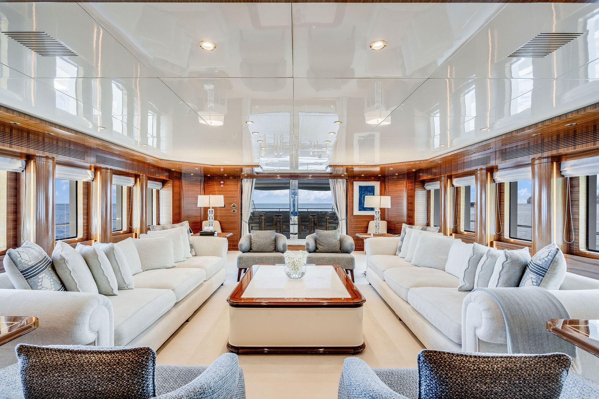 a living room on a yacht with a lot of furniture and a table