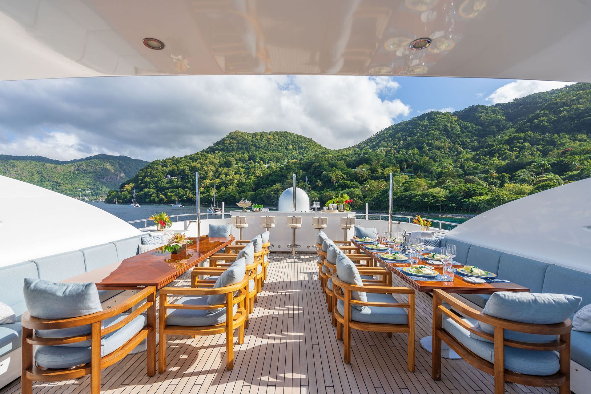 there are many chairs and tables on the deck of a yacht