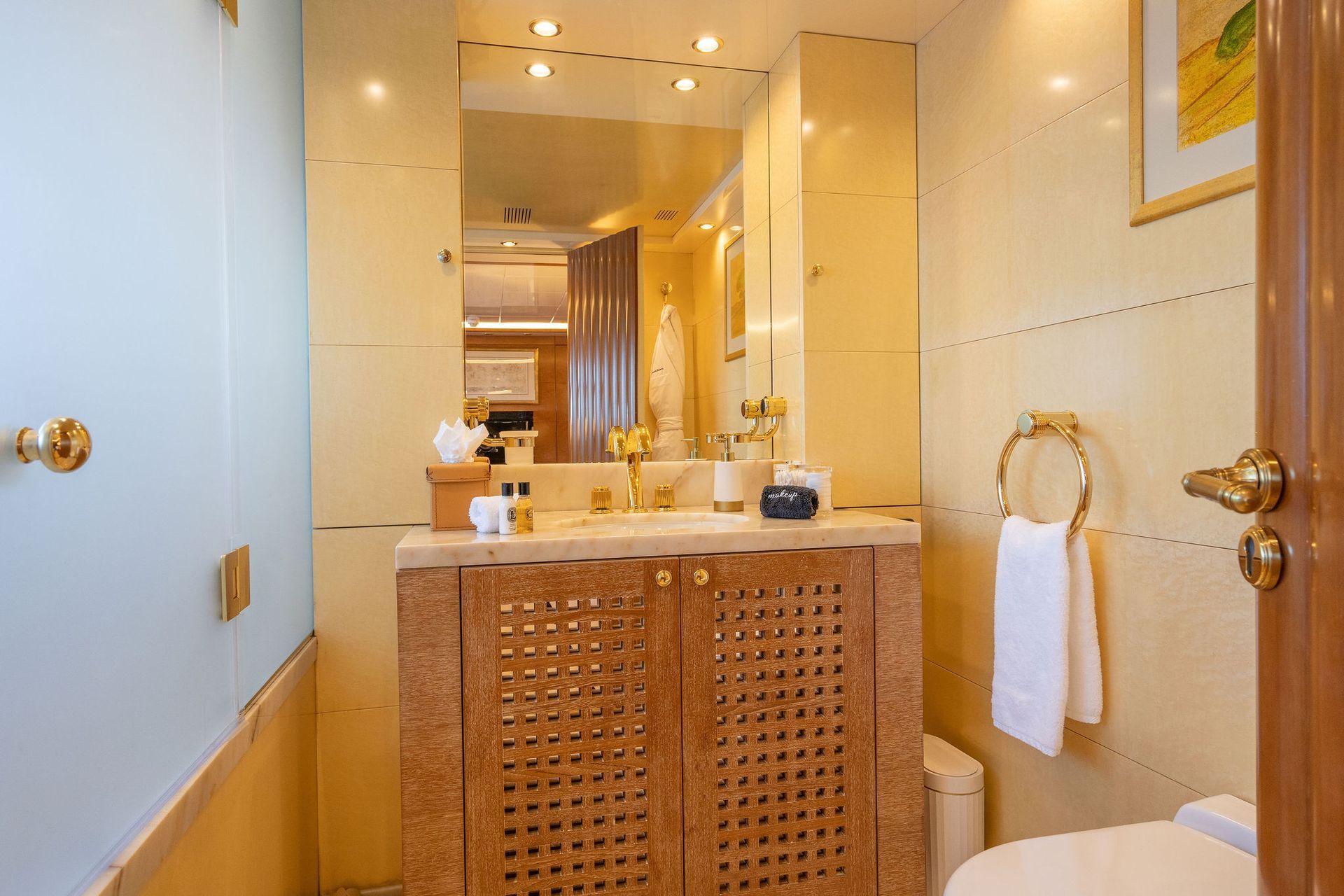 a bathroom with a sink, toilet and mirror