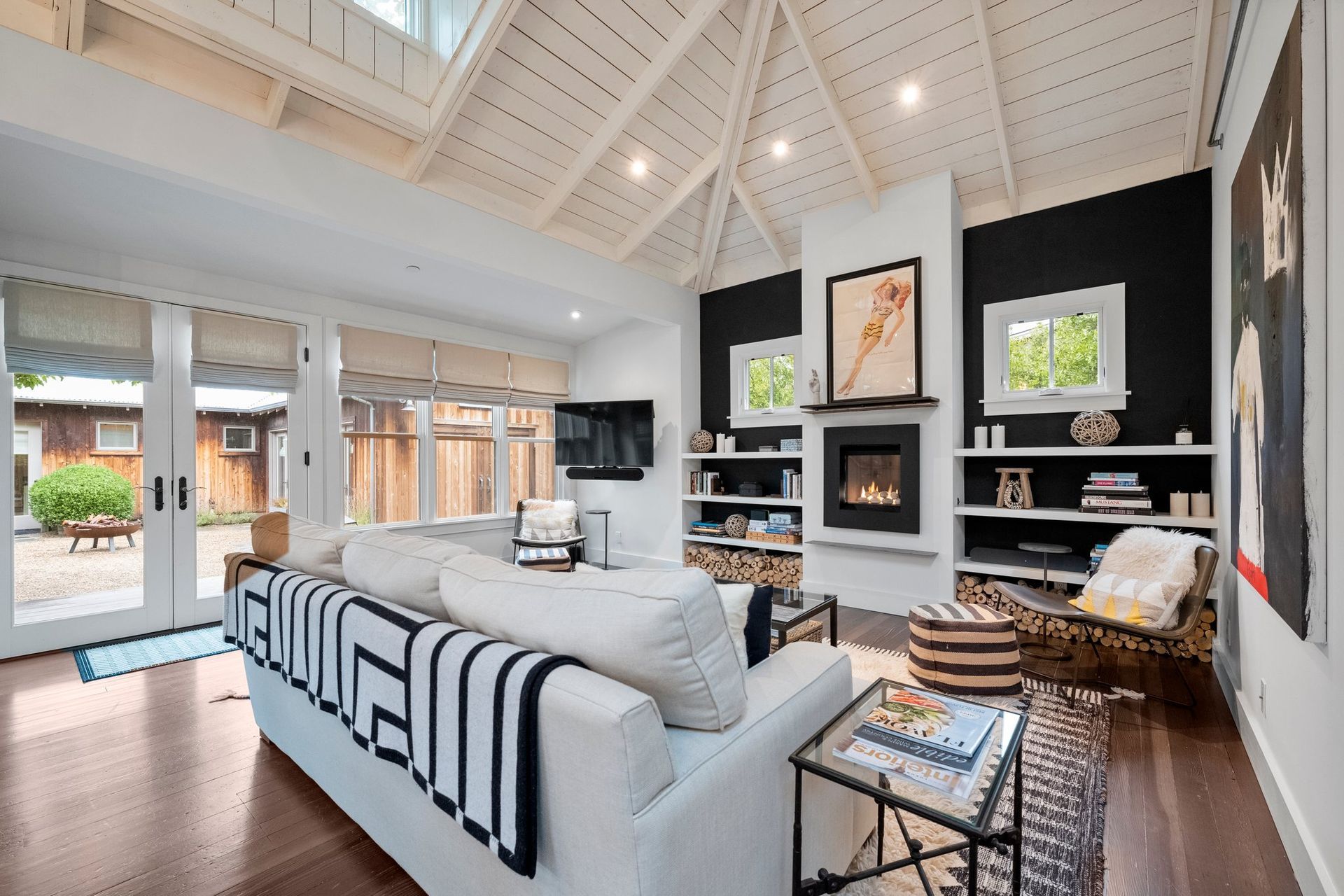 a living room with a white couch and a fireplace