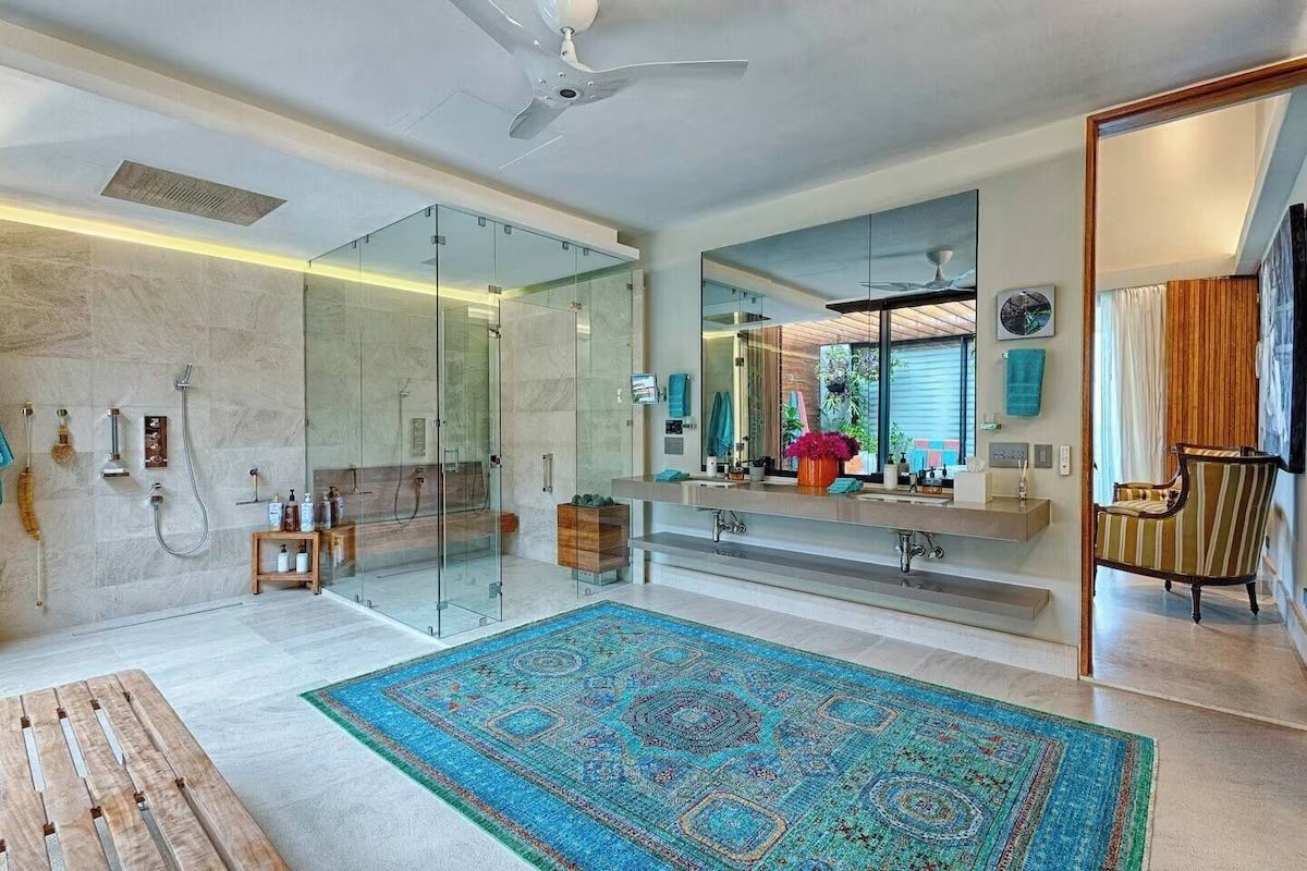 a bathroom with two sinks, a tub, and a walk in shower