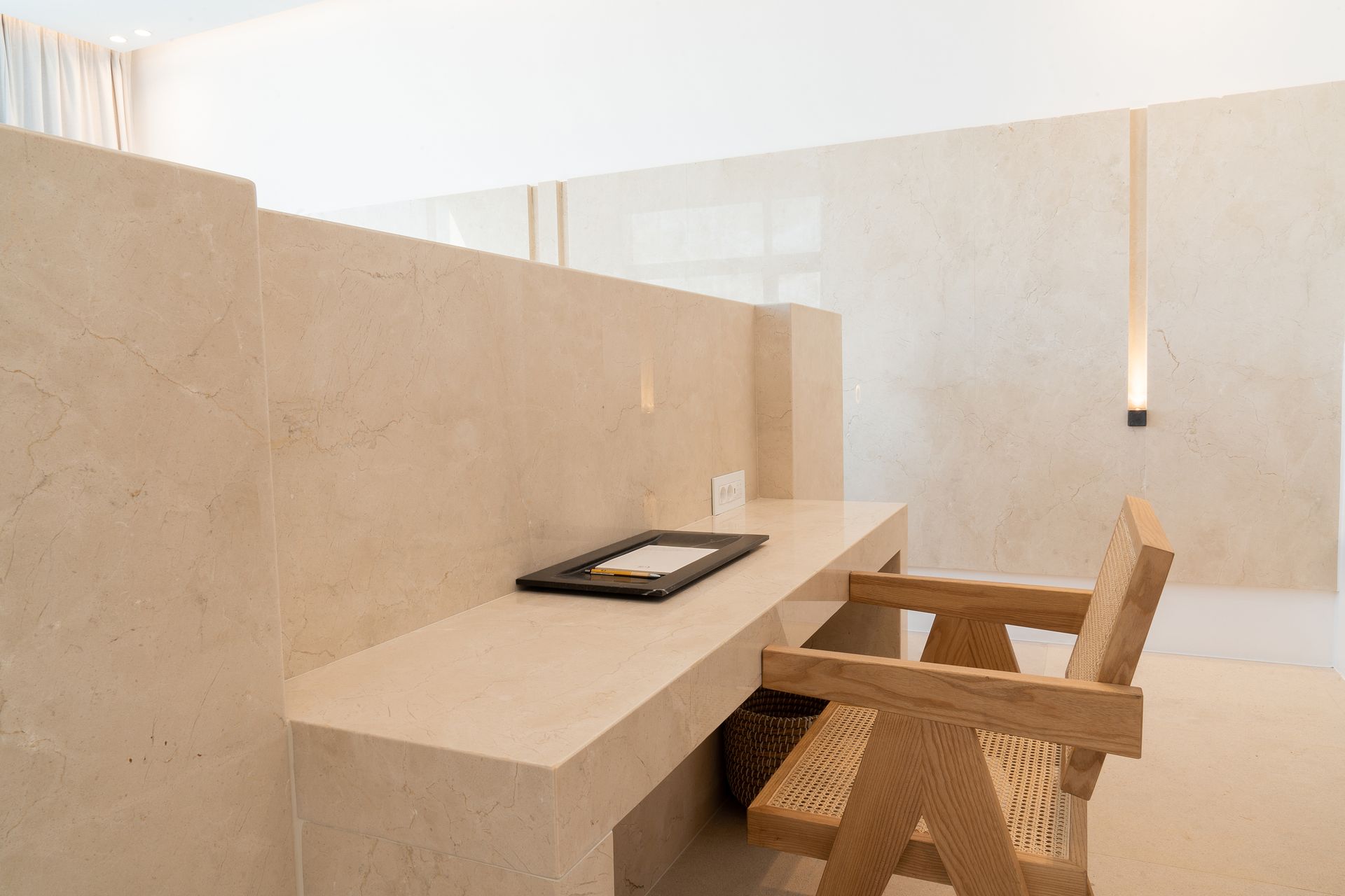 a wooden chair is sitting next to a desk in a room