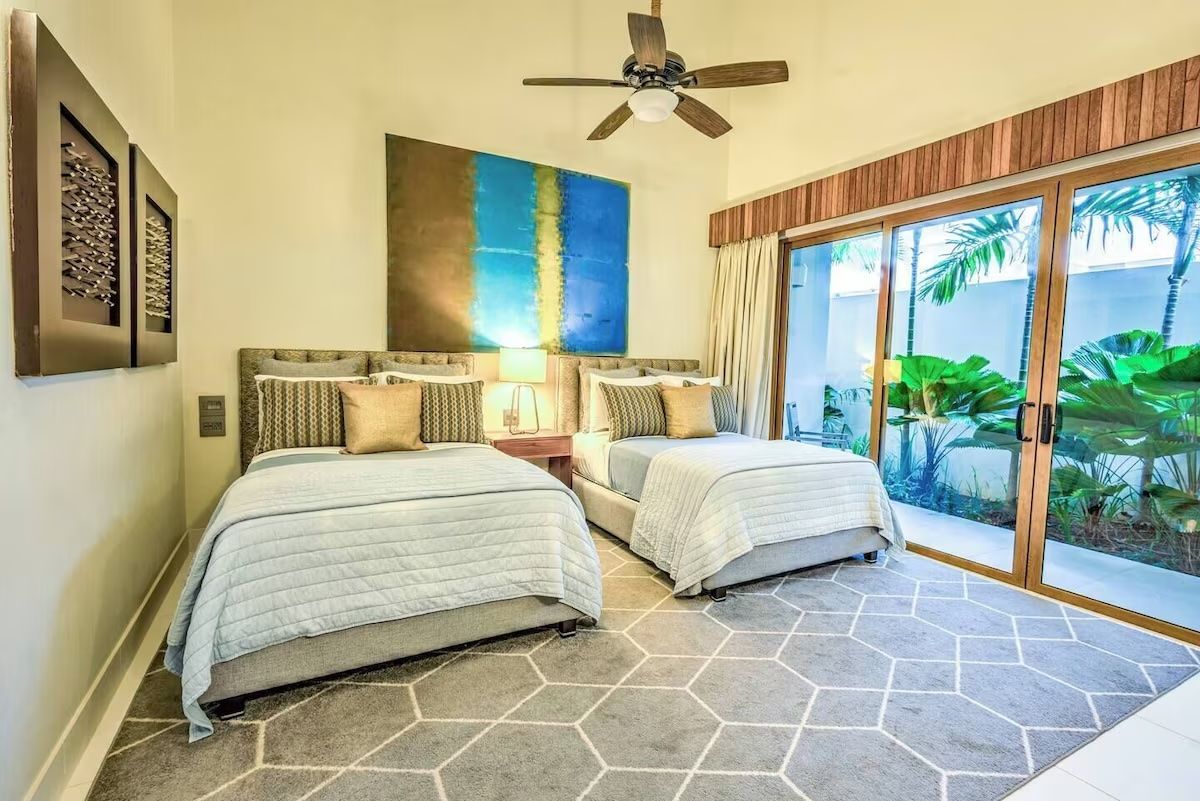 a bedroom with a large bed and a ceiling fan