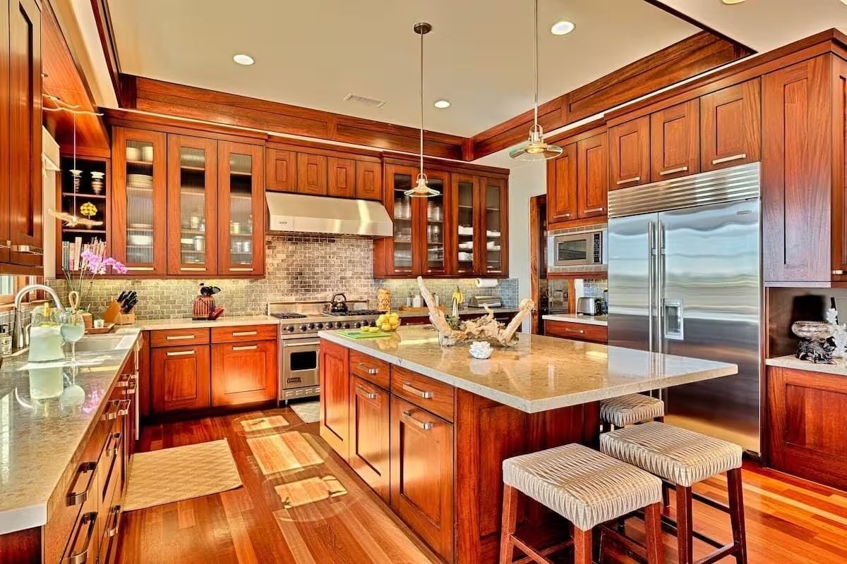 a kitchen with wooden cabinets, stainless steel appliances, and a large island