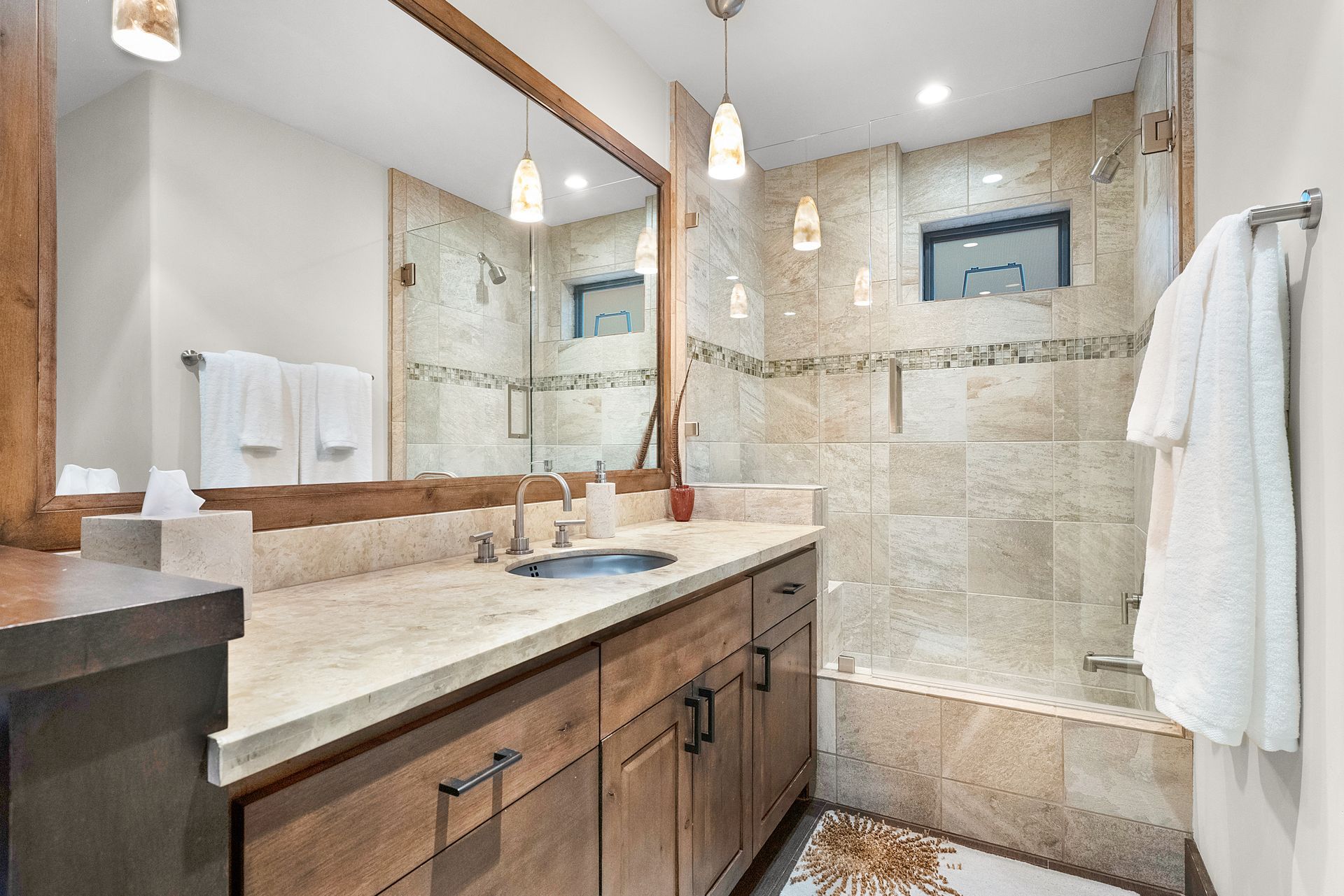 a bathroom with a sink, mirror and bathtub