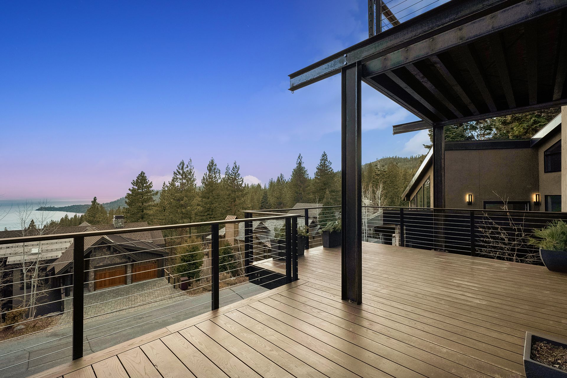 a large deck with a view of the ocean and trees