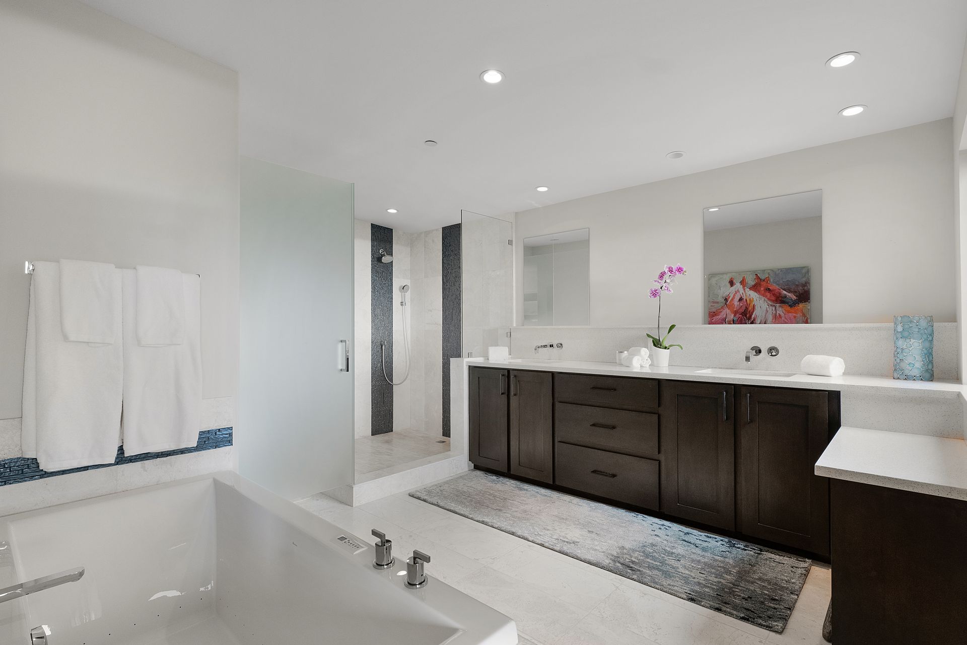 a bathroom with a tub, sink, and mirror