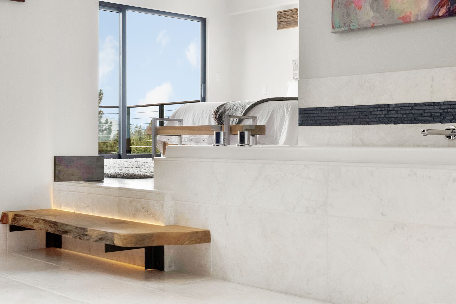 a bathroom with a bathtub and a wooden bench