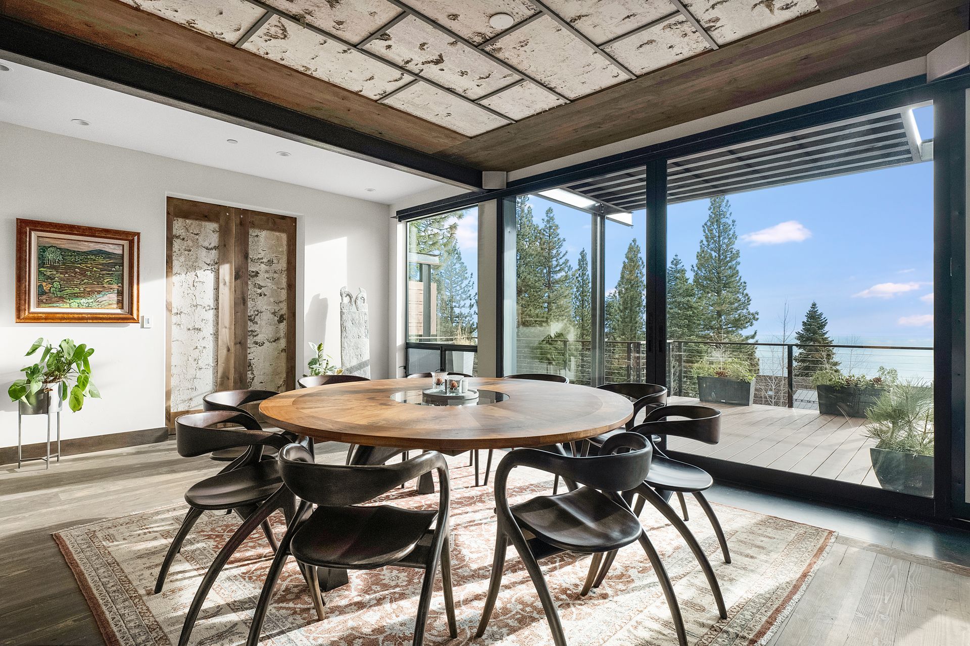 a dining room with a table and chairs and a large window