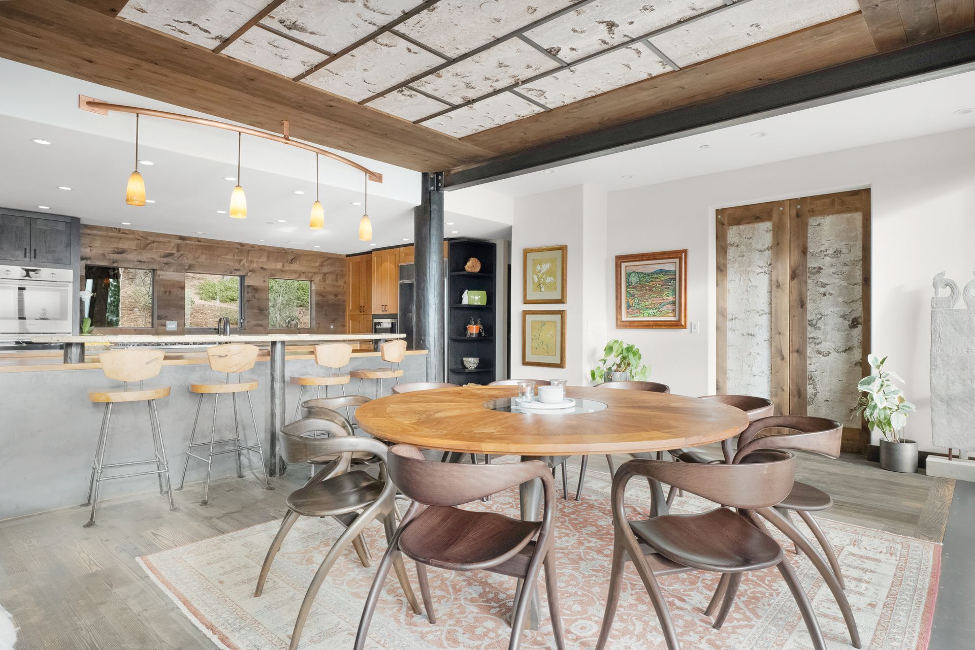 a dining room with a round table and chairs and a rug