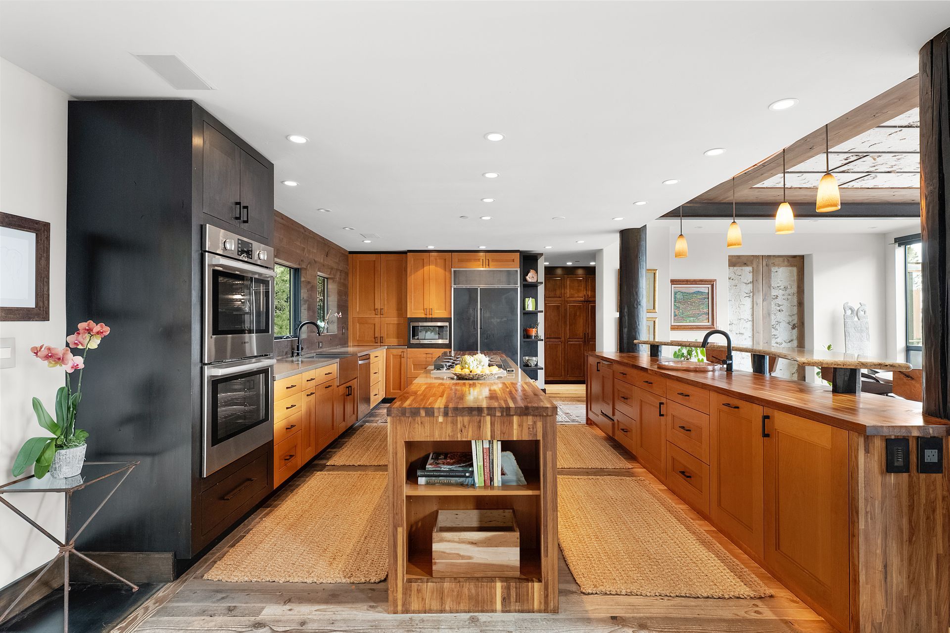 a large kitchen with wooden cabinets and stainless steel appliances