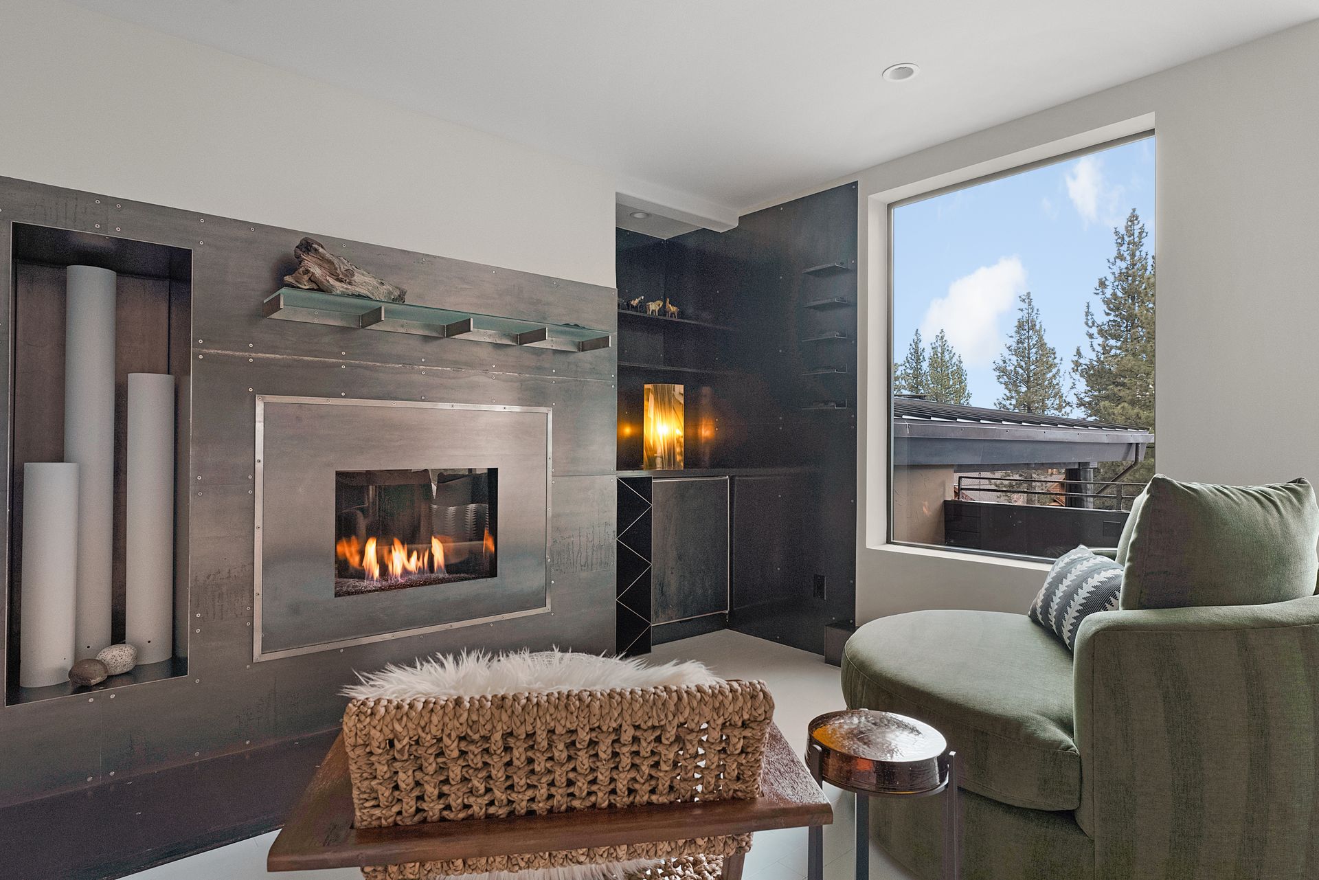 a living room with a fireplace and a large window