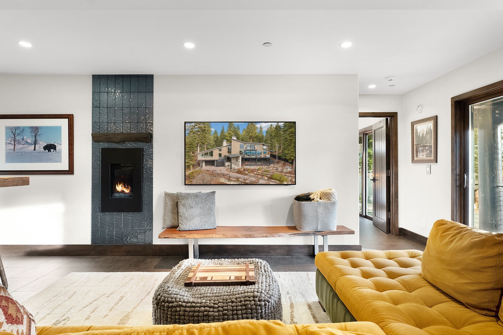 a living room with a yellow couch and a fireplace