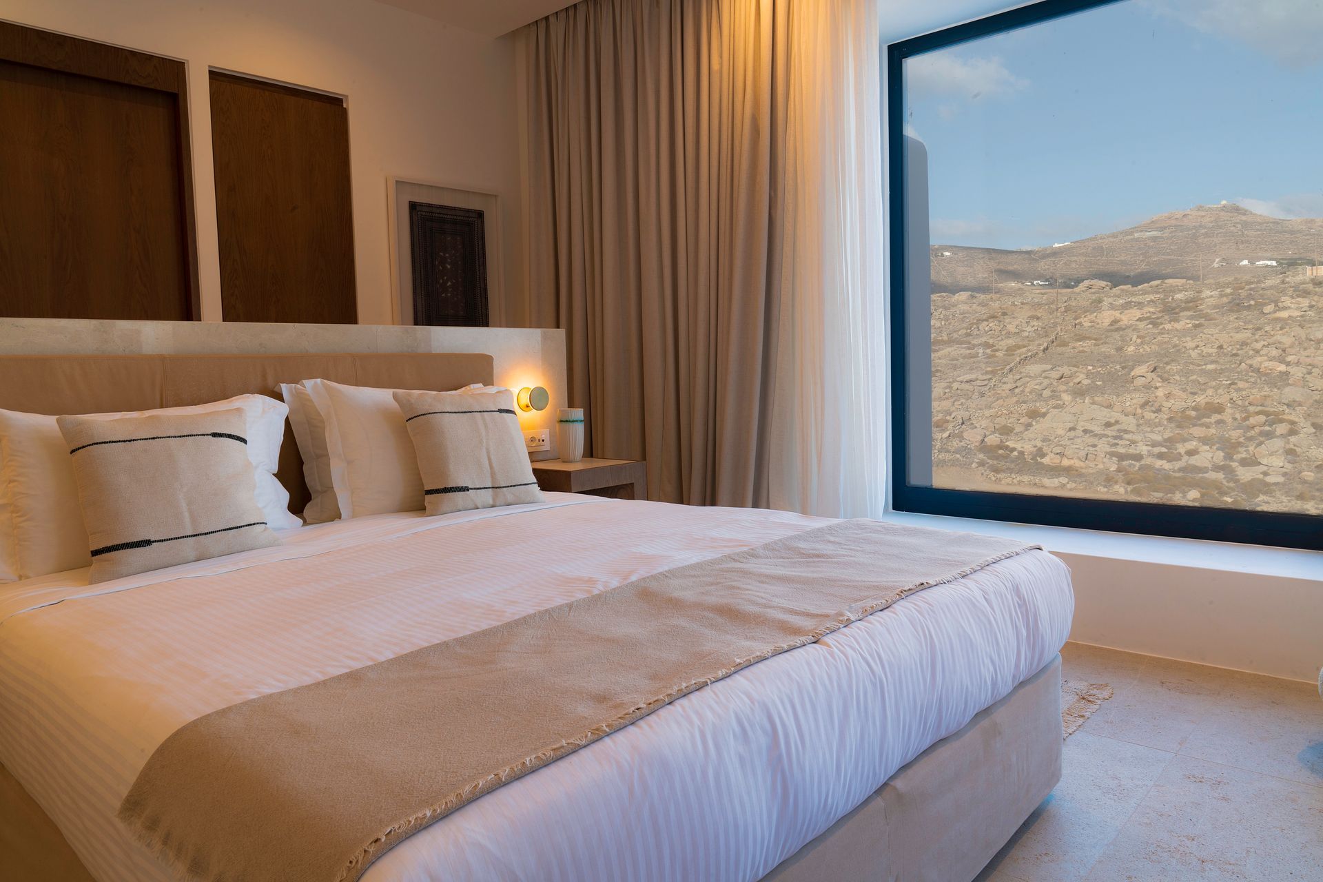 a hotel room with a large bed and a large window