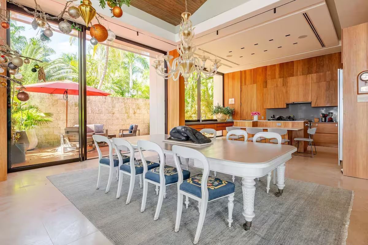 there is a long dining table in the middle of the room